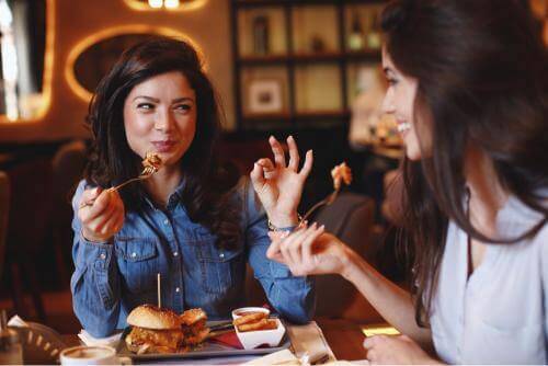 Two girls eating at a restaurant