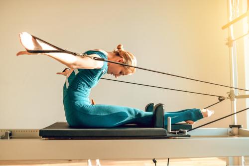 working out in a reformer pilates